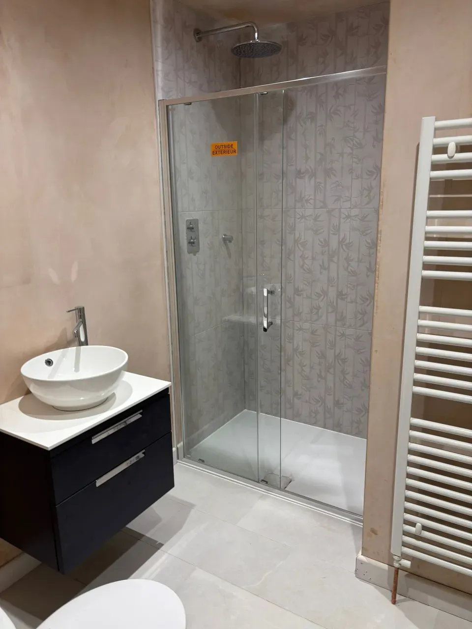 Gold-accent bathroom with feature tiling and premium brassware